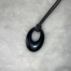 Craved stone pendant on leather cord